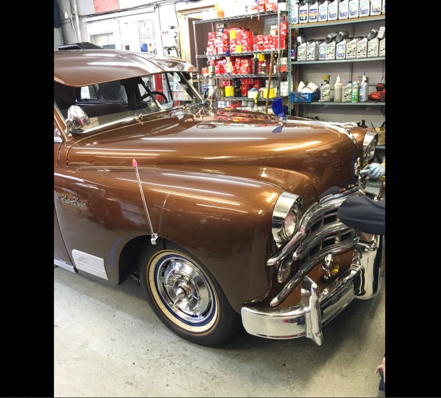 Brown classic Chevrolet inside the shop with chrome detailing