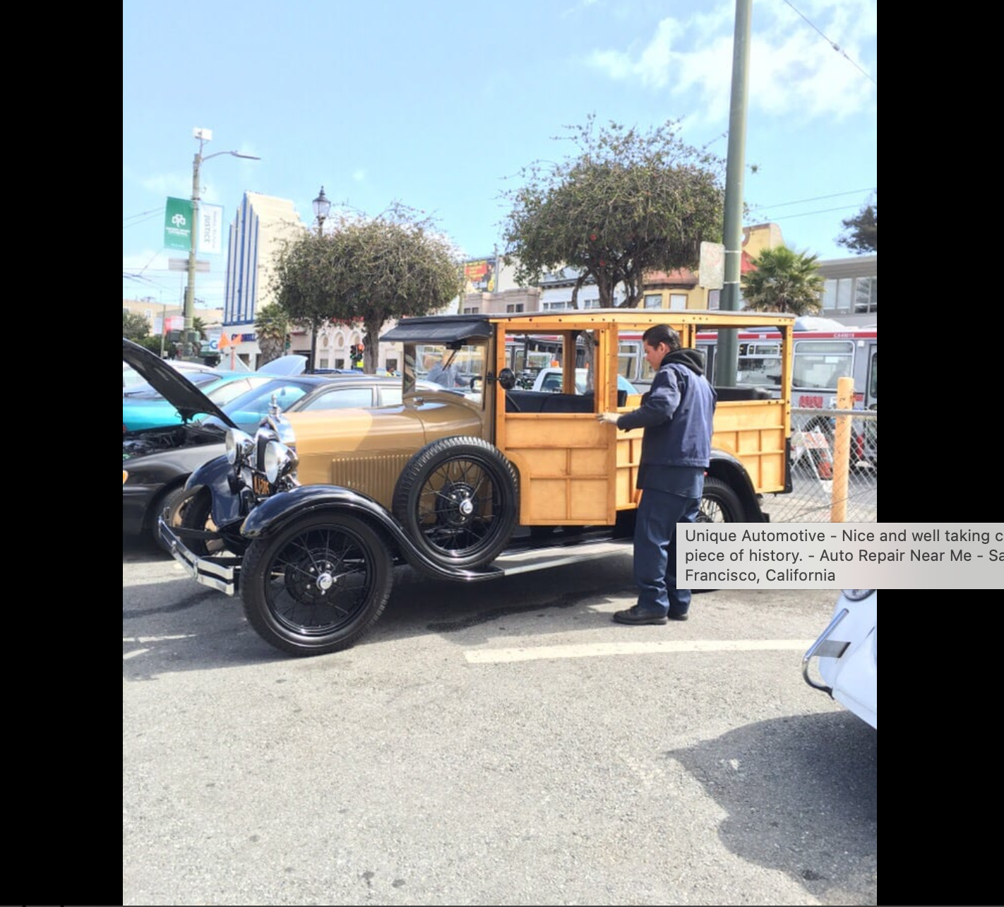 Classic wood-bodied vintage car outside Unique Automotive