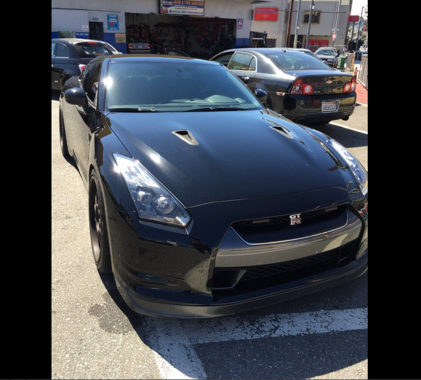 Black Nissan GT-R parked outside Unique Automotive