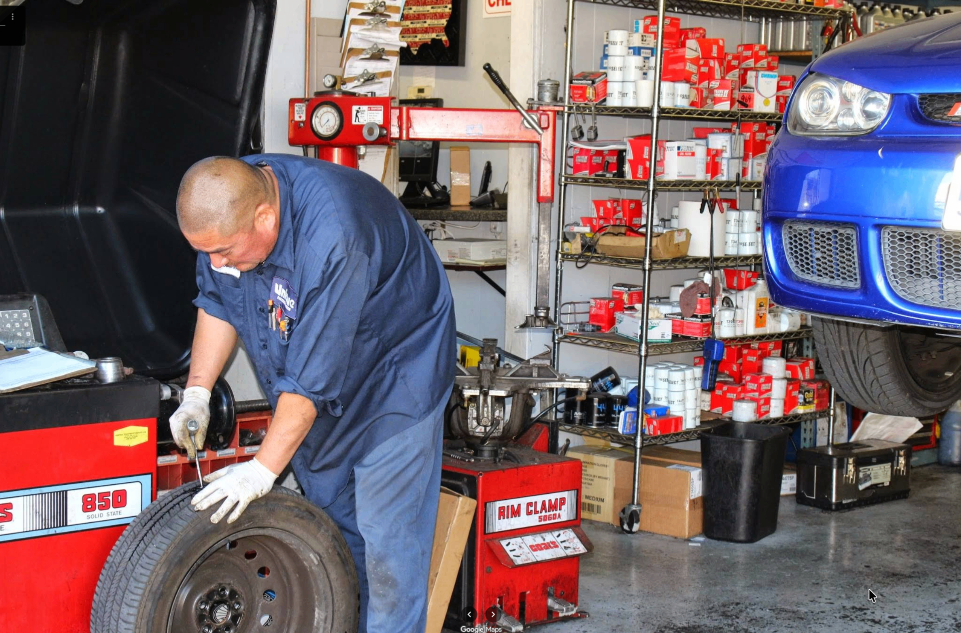 Mechanic mounting a tire on the rim clamp machine